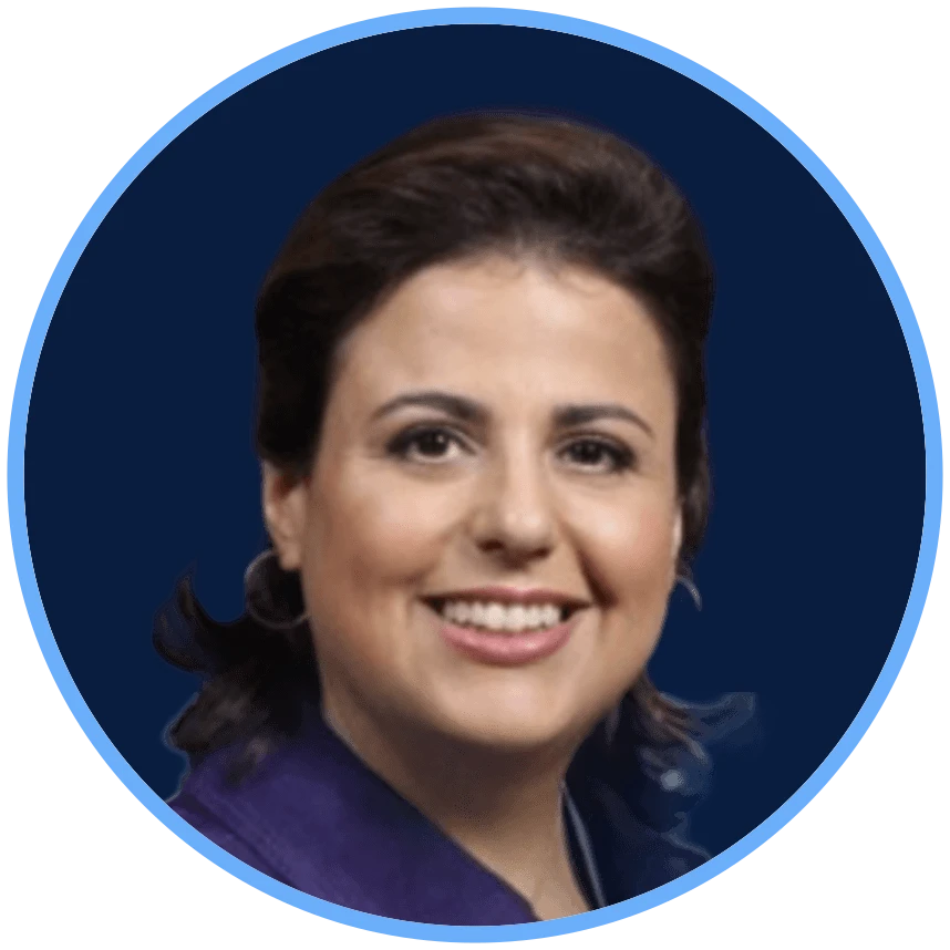 Professional woman with dark hair, smiling, wearing a purple blazer against a blue and white background.