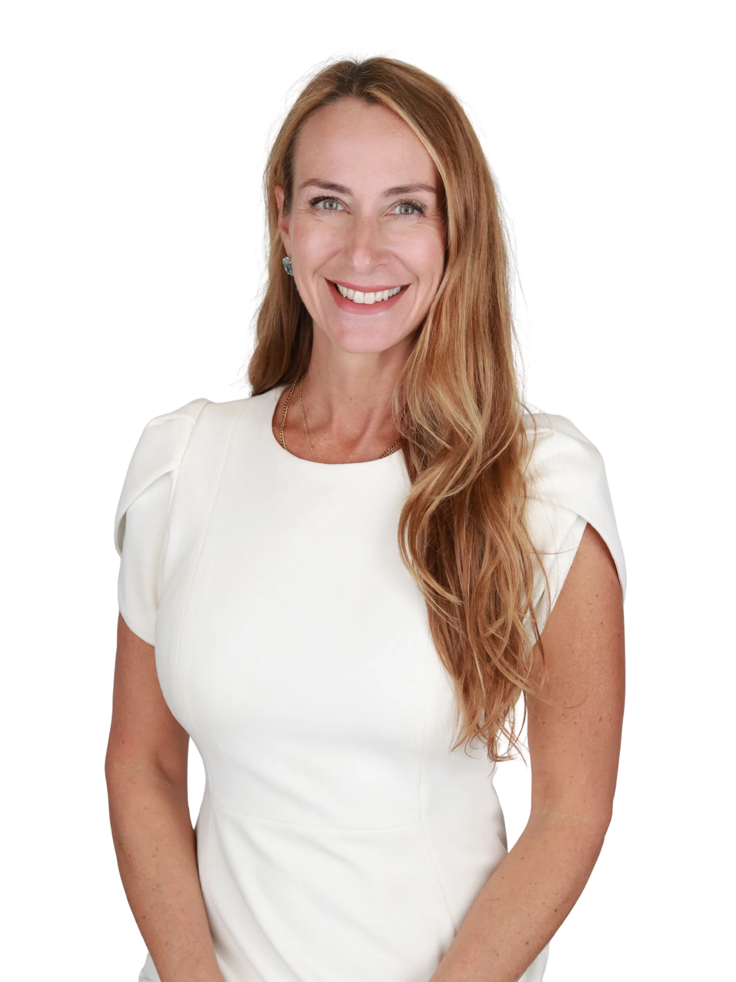 A woman with long, wavy red hair smiling while wearing a white dress.